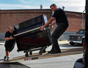 2-men-moving-a-piano-into-a-truck